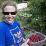 Ramey Harris-Tatar enjoys some raspberries from the Olin garden